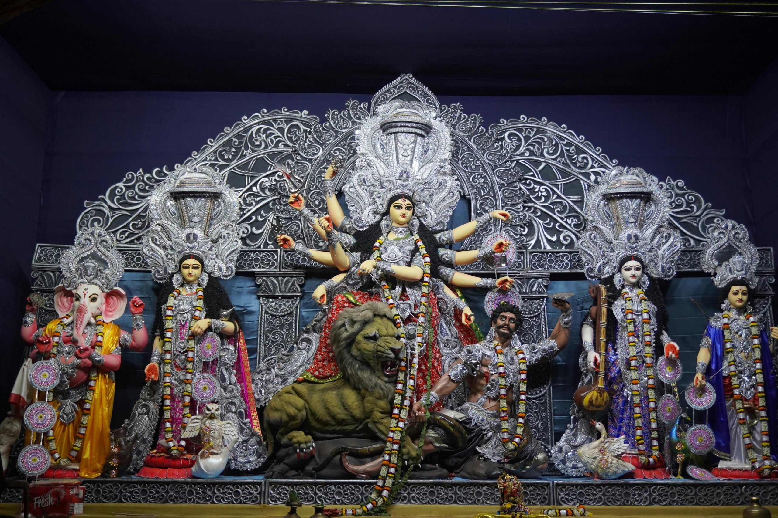 Vibrant statues of Hindu deities displayed during the Durga Puja festival.